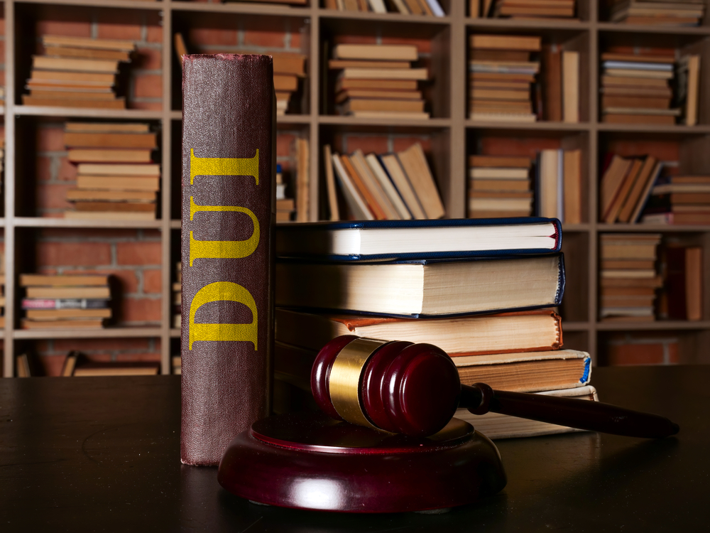 DUI law or driving under the influence book stands next to the gavel.