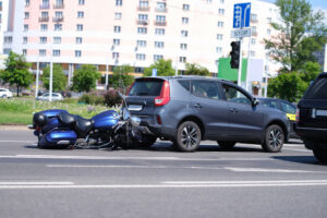 Motorcycle crashed into back of car on road closeup