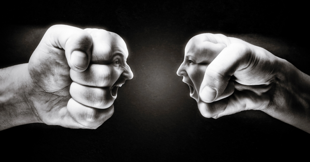 Two clenched fists facing each other, each with a face on the knuckles, yelling at each other, representing conflict or confrontation