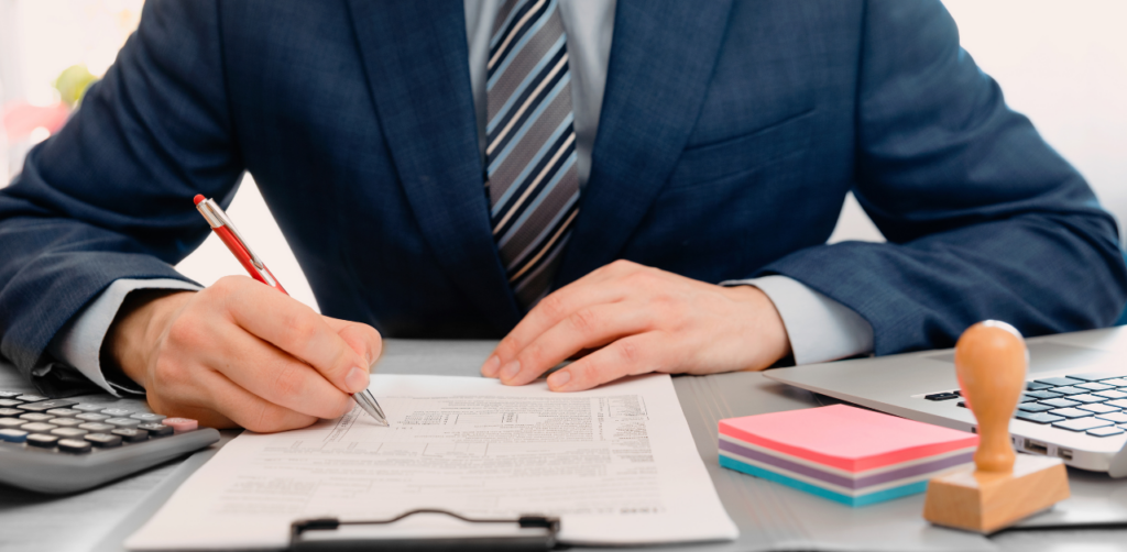 Business professional in a suit filling out legal documents at a desk, symbolizing formal legal assistance and paperwork