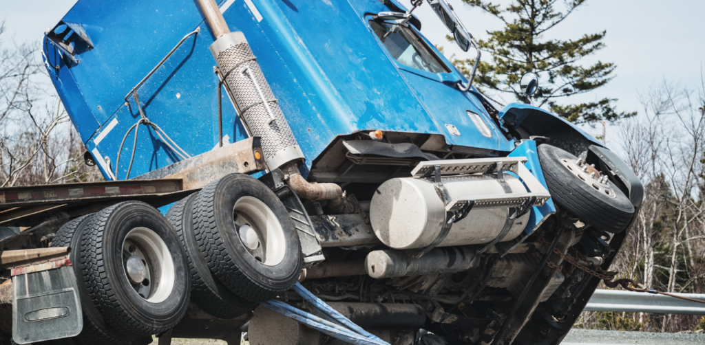 Damaged blue truck after crash, illustrating road accident scene linked to personal injury claim and liability