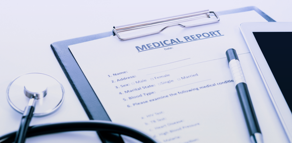 Clipboard holding a medical report beside a stethoscope, pen, and tablet