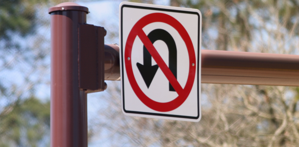 Traffic sign with a crossed-out U-turn symbol indicating no U-turns allowed